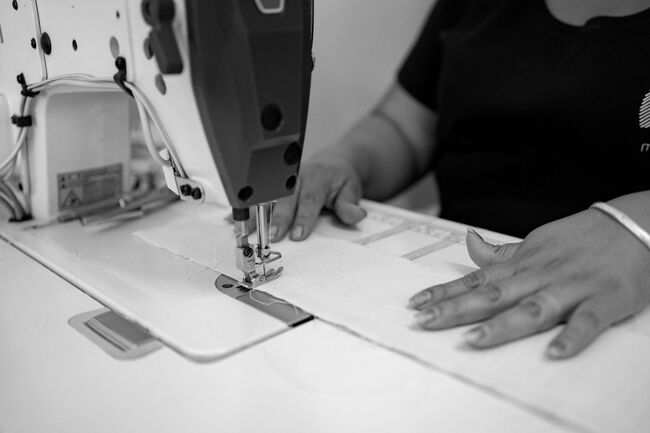 A woman stitching a piece of fabric