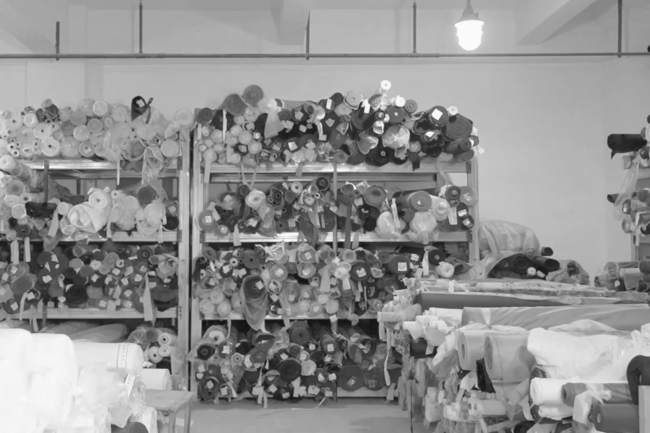 Spools of fabric against a back wall